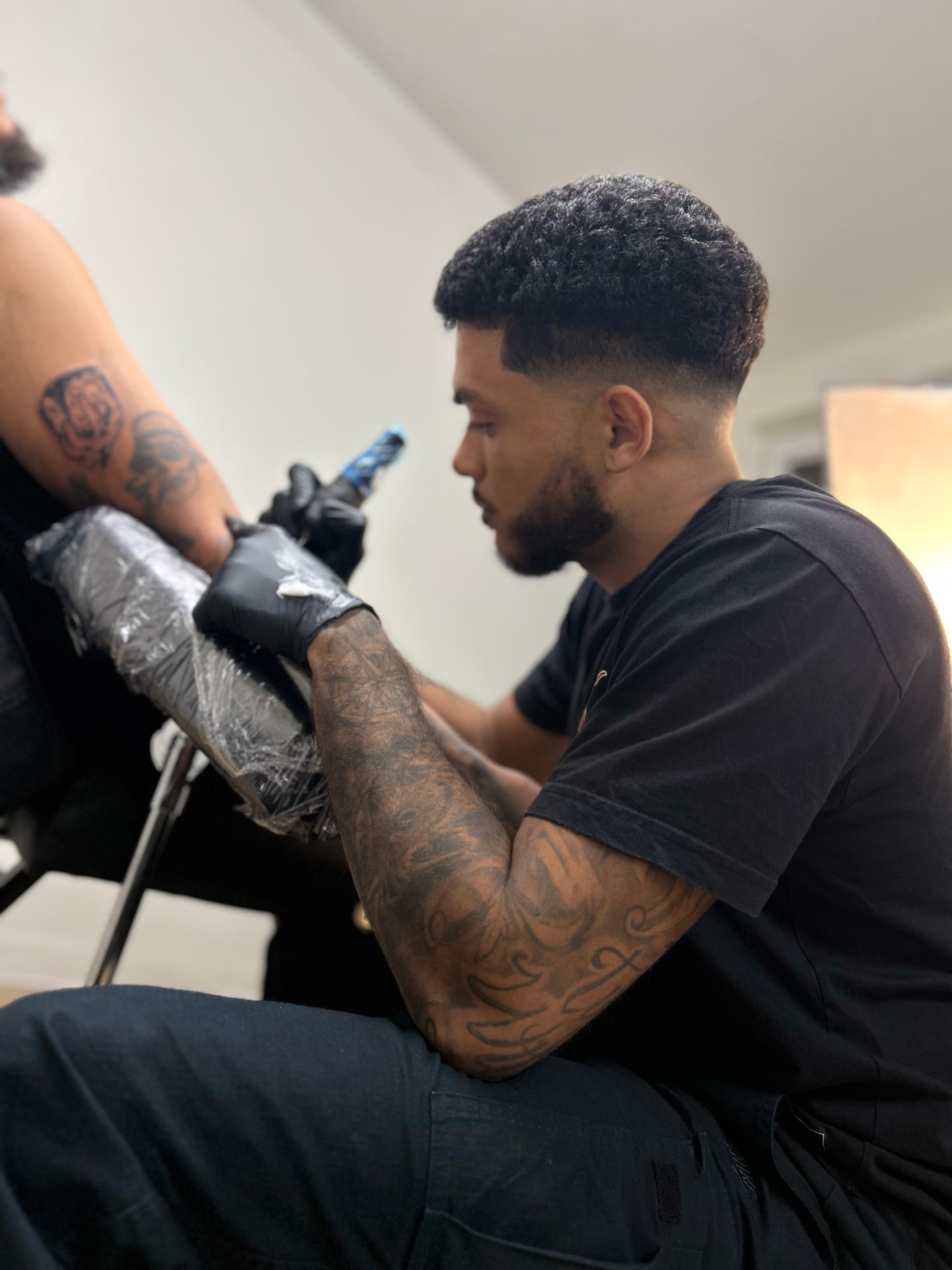 Vito tattooing a client in his Toronto studio